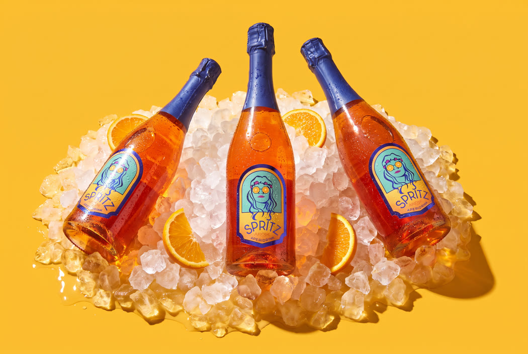 Bottles set into crushed ice on a yellow ground